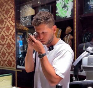 Jewelry appraiser near Philadelphia closely examining a luxury watch with a jeweler's loupe in an upscale store.