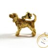 Detailed 14k yellow gold dog pendant charm with a loop for a chain, showcasing its intricate design.
