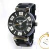 Louis Vuitton Tambour GMT watch showing time, date, and "AUTOMATIQUE GMT" text on a black and silver dial.