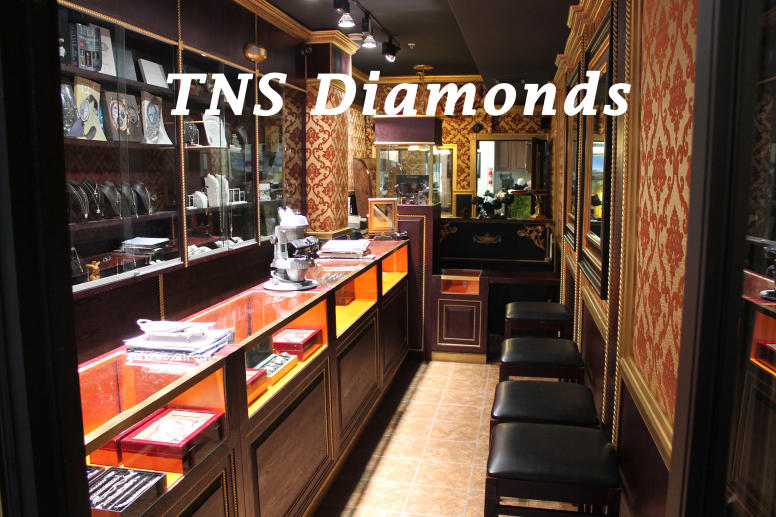 Interior of a luxury jewelry store featuring watch and jewelry displays, highlighting exchange jewelry, trade-in, and upgrade your watch services.