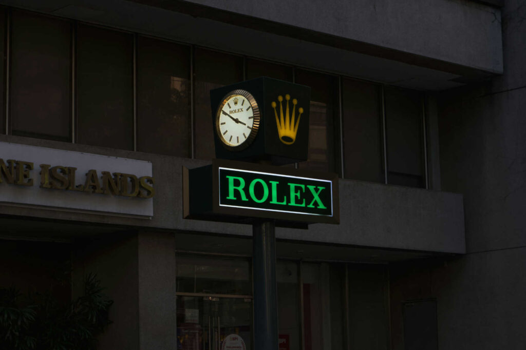 Street sign featuring the Rolex logo and clock, often seen in discussions about Rolex nicknames.