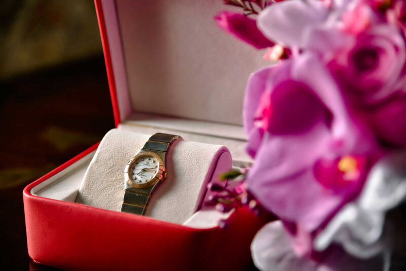 womens luxury watches, gold and steel watch in a red gift box with pink flowers