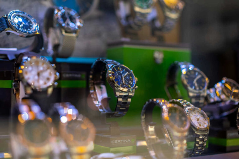 Fake Rolex authentication, display of luxury watches in a jeweler’s case.