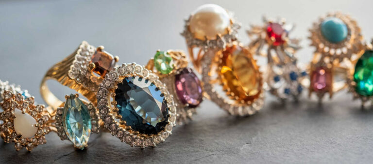 Sustainable jewelry and recycled gold rings with colorful gemstones.