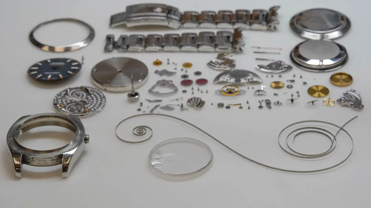 Milgauss watch parts carefully laid out for professional repair and servicing.