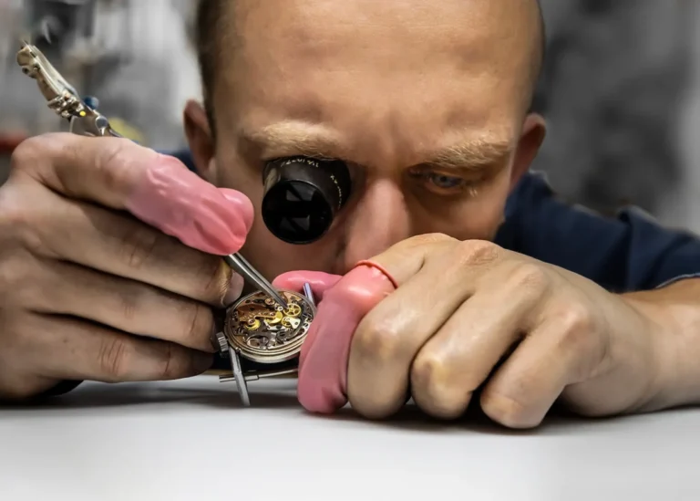Paul Bogard, head watchmaker at TNS Diamonds, servicing a luxury watch movement at his bench on Philadelphia's Jewelers' Row